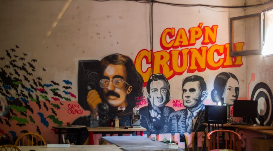 A spray-painting inside Calafou depicting Captain Crunch, a telephone hacker from the 1970s.